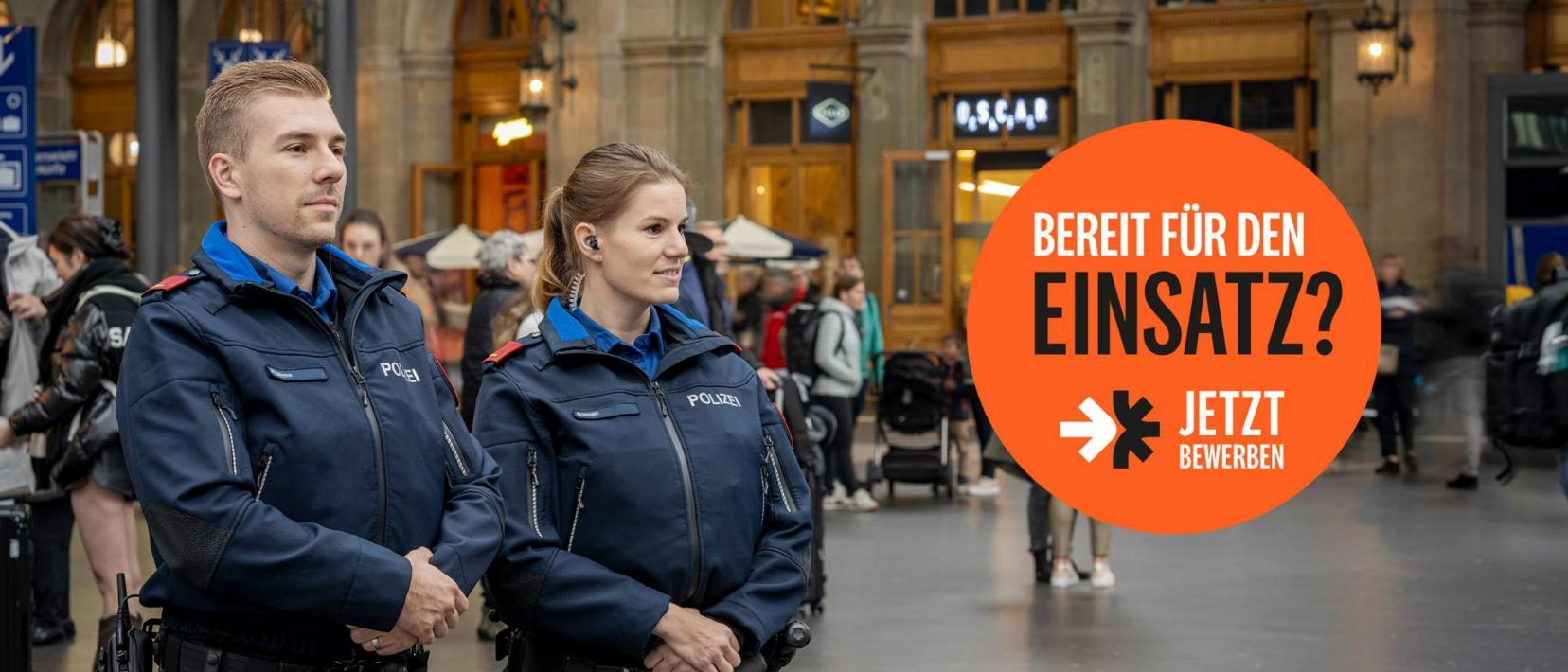 Eine Polizistin und ein Polizist beobachten das Geschehen am Zürcher Hauptbahnhof.