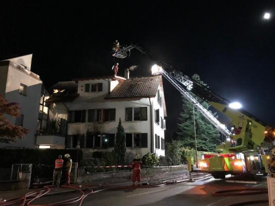 Brandruine und Feuerwehrleute beim Einsatz