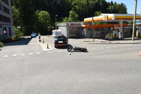 Unfallstelle mit einem Personenwagen und einem Motorrad, welches am Boden liegt.