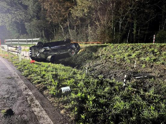 Das Auto liegt auf dem Dach neben der Strasse