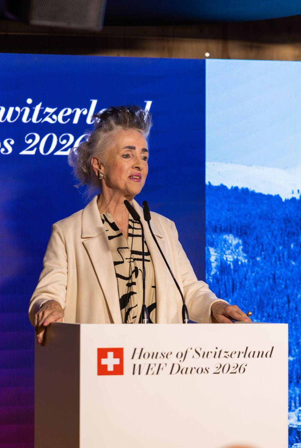 Eine Frau im Blazer hält eine Rede am Podium