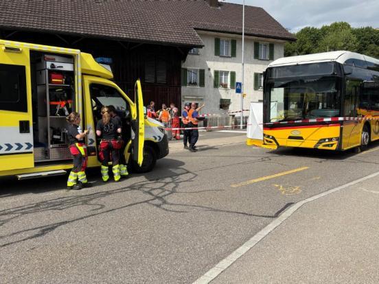 Der beteiligte Linienbus in Unfallendstellung. Davor steht ein Rettungswagen mit Rettungssanitätern