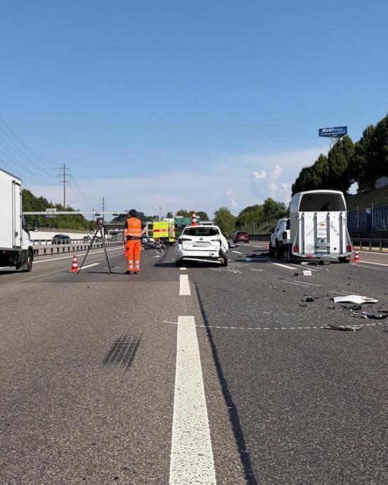 ein weisses Unfallfahrzeug und ein Auto mit Pferdeanhänger steht auf einer Autobahn. Auf der Strasse liegen Trümmerteile.