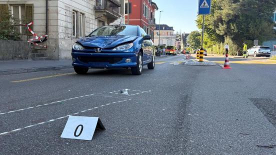 Ein beschädigtes, blaues Auto steht auf der Strasse. Unfallspuren sind eingezeichnet