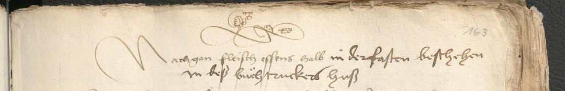 Handschriftlicher Titel mit Ornament darüber