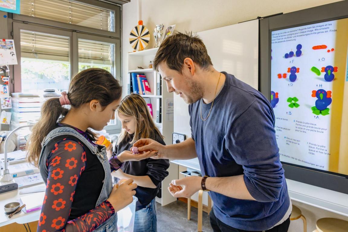 Der Student Noam Renfer begutachtet das Resultat einer Schülerin