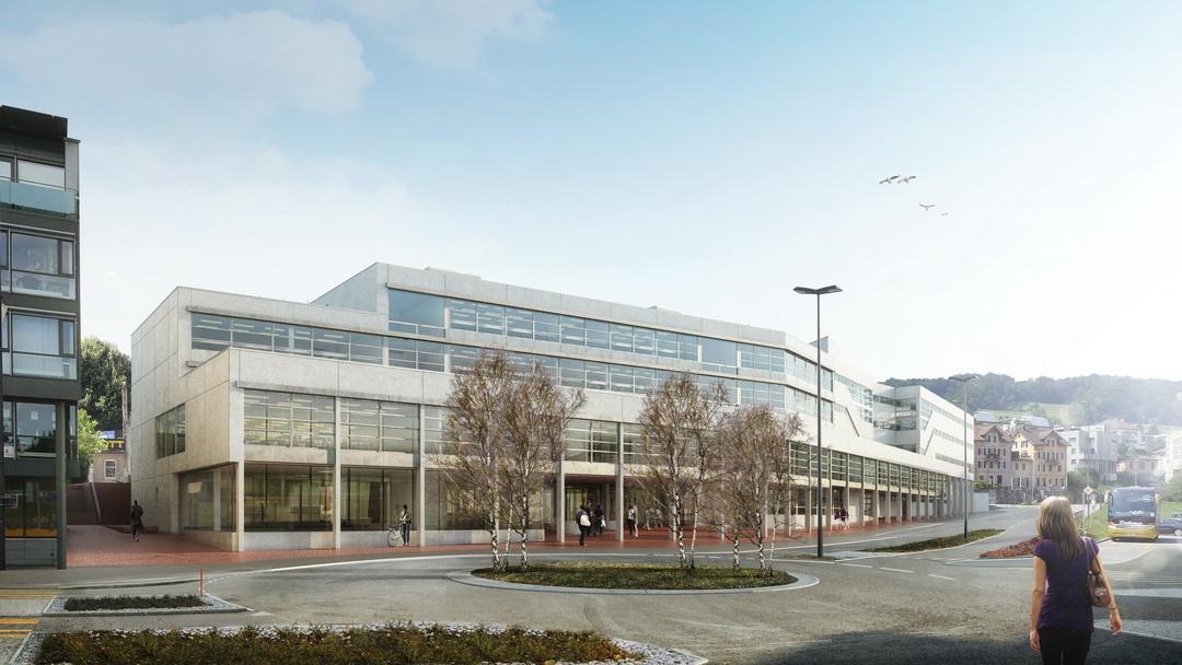 Aussenansicht an das Gebäude mit grossen Glasflächen. Im Vordergrund des Bildes ist die Alte Landstrasse mit Kreisel und Fussgänger.