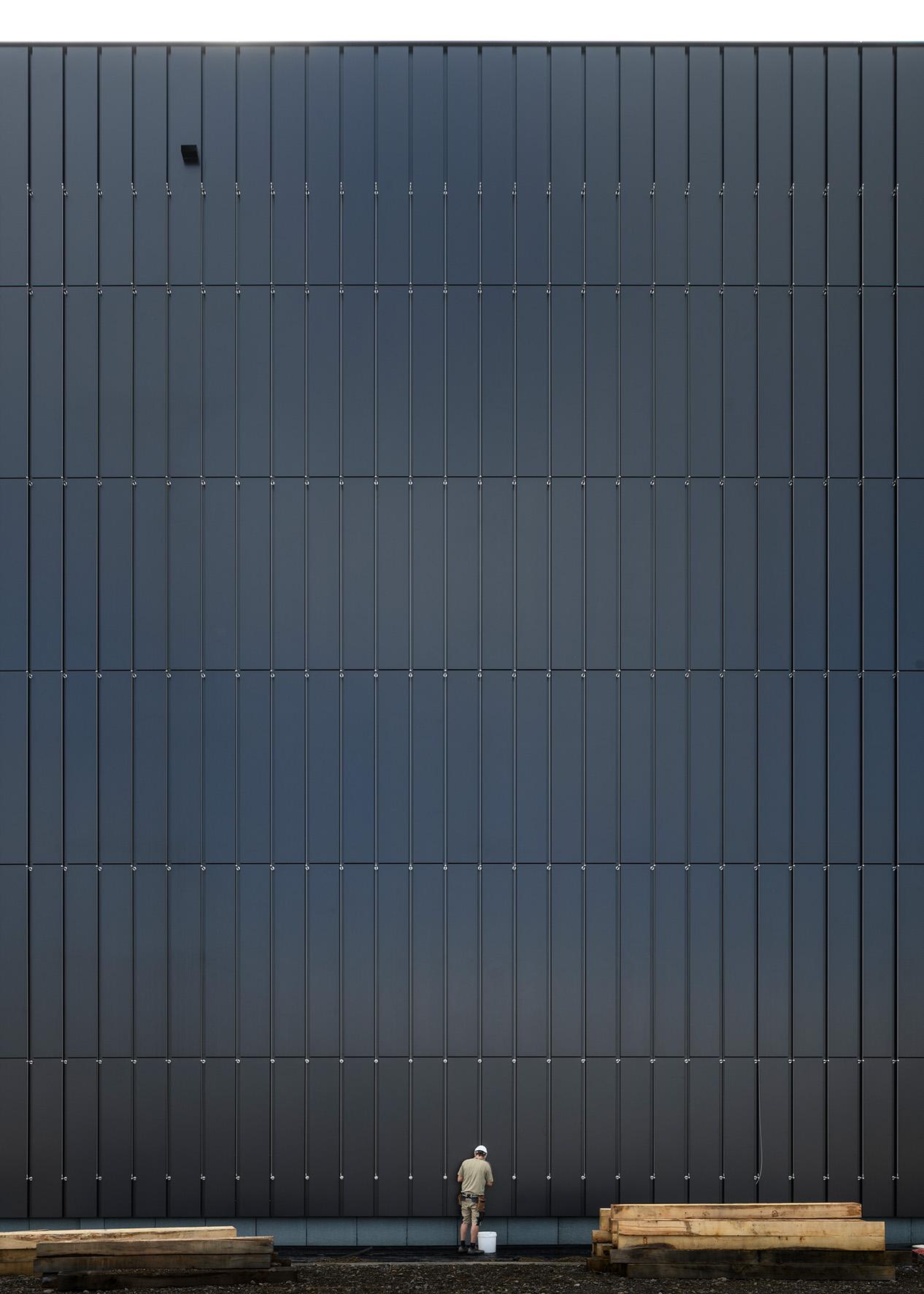 Aussenfassade des PJZ-Gebäudes im August 2021 mit Bauarbeiter davor