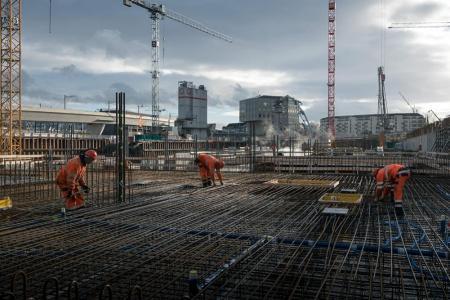 Die PJZ-Baustelle im Dezember 2017. Arbeiter in oranger Arbeitskleidung stehen im Einsatz, im Hintergrund mehrere Kräne.