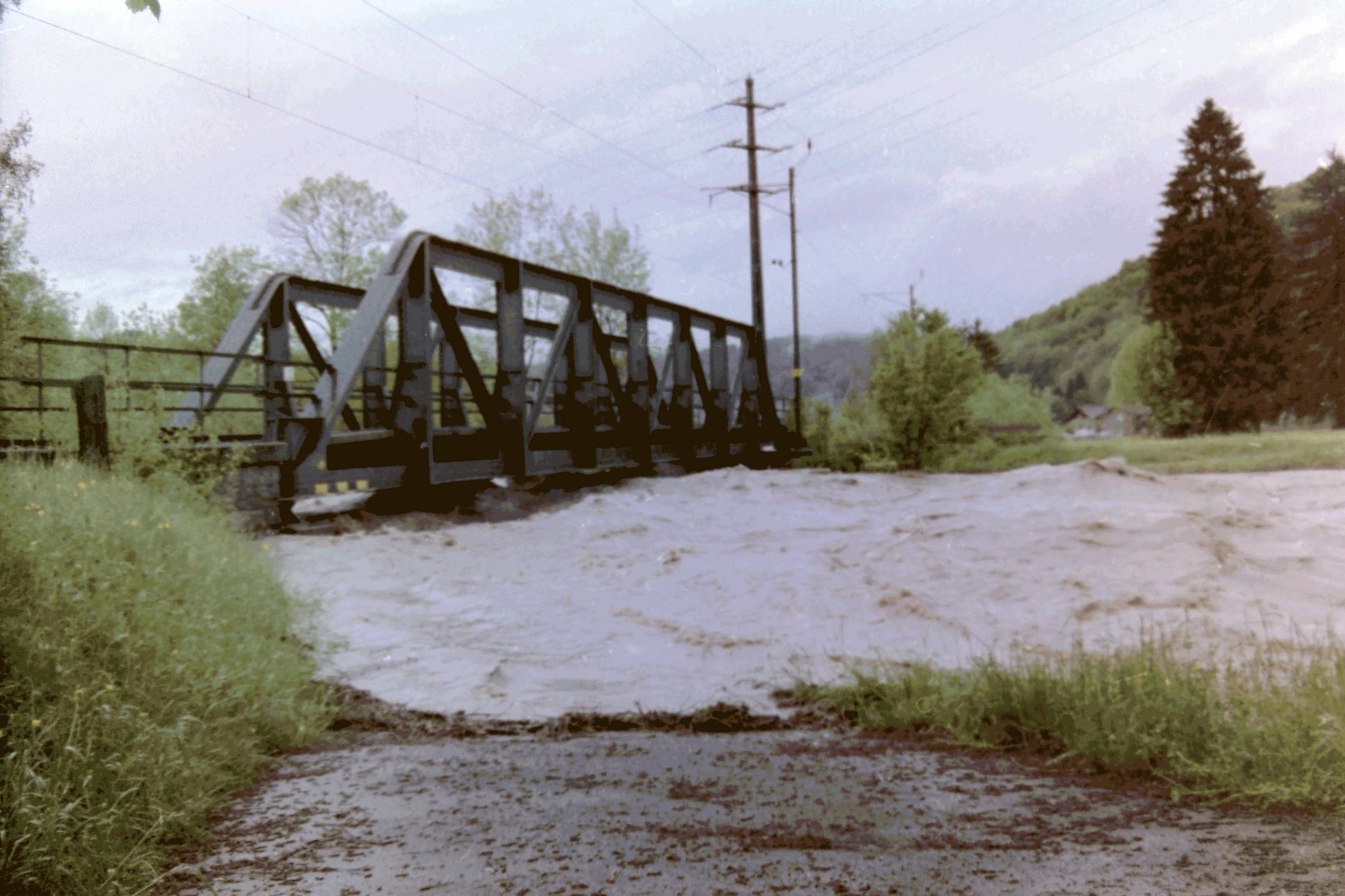 Die Töss bei Hochwasser. Der Pegelstand ist sehr hoch. Das Wasser kommt sehr nahe an die Unterkante der SBB-Brücke