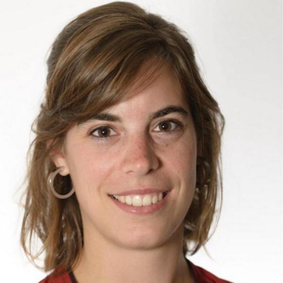 Porträt einer lächelnden Frau mit braunem Haar und rotem Oberteil