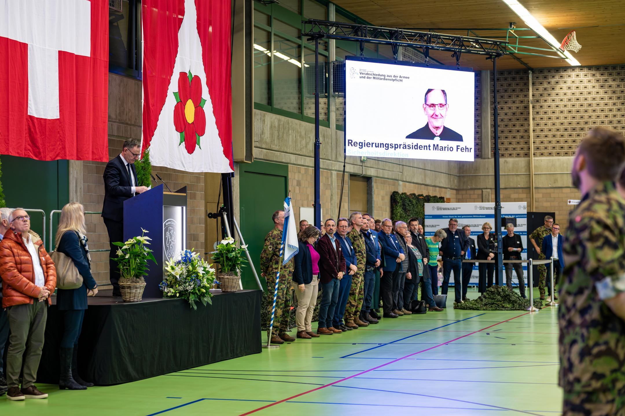 Links und rechts neben der Bühne mit Mario Fehr stehen zahlreiche Gäste