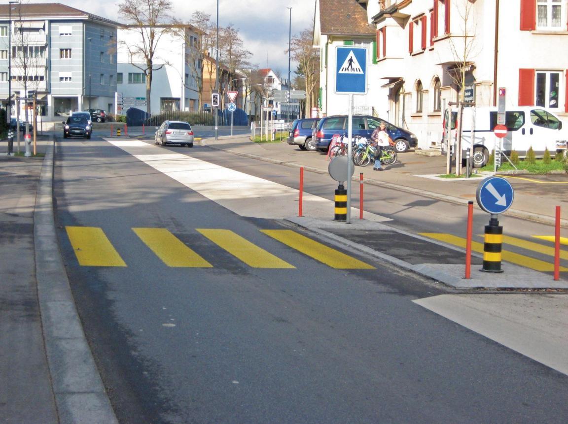 Strassenabschnitt mit einem Mehrzweckstreifen, welcher vollflächig farbig oder mittels Belagswechsel von der Fahrbahn abgetrennt ist