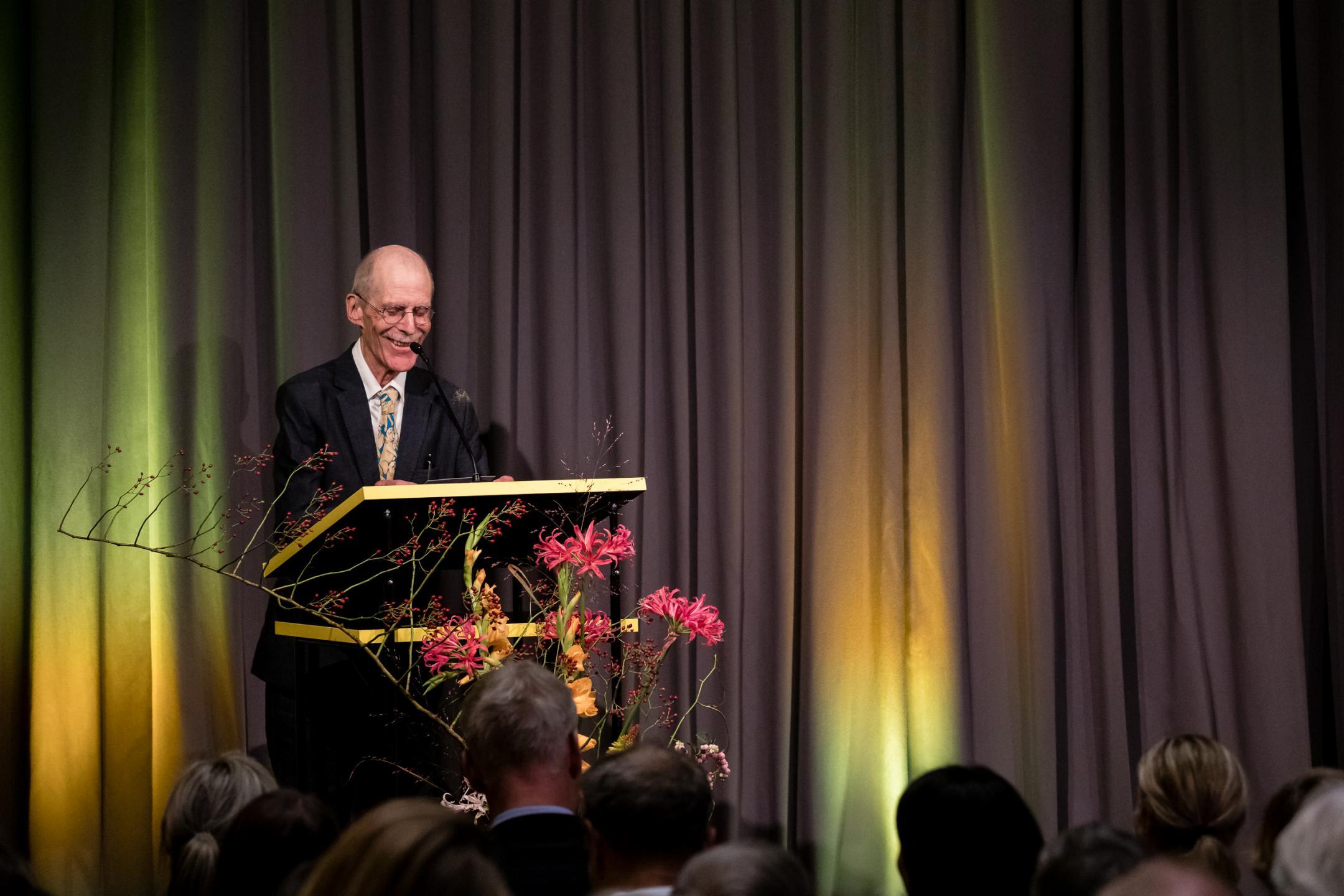 Hannes Binder hinter dem Rednerpult, strahlend