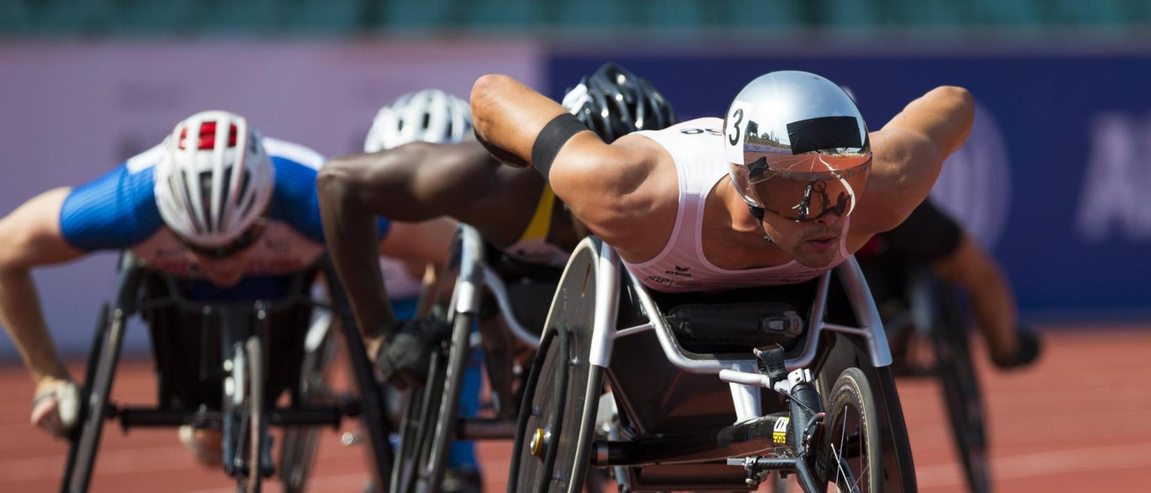 Athleten im Rollstuhl auf einer Leichtathletik-Rundbahn