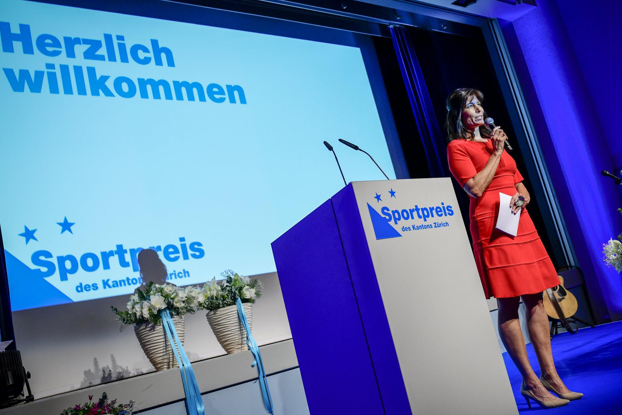 Sportpreis des Kantons Zürich 2022: Moderatorin Janine Geigele spricht in ein Handmikrofon auf der Bühne