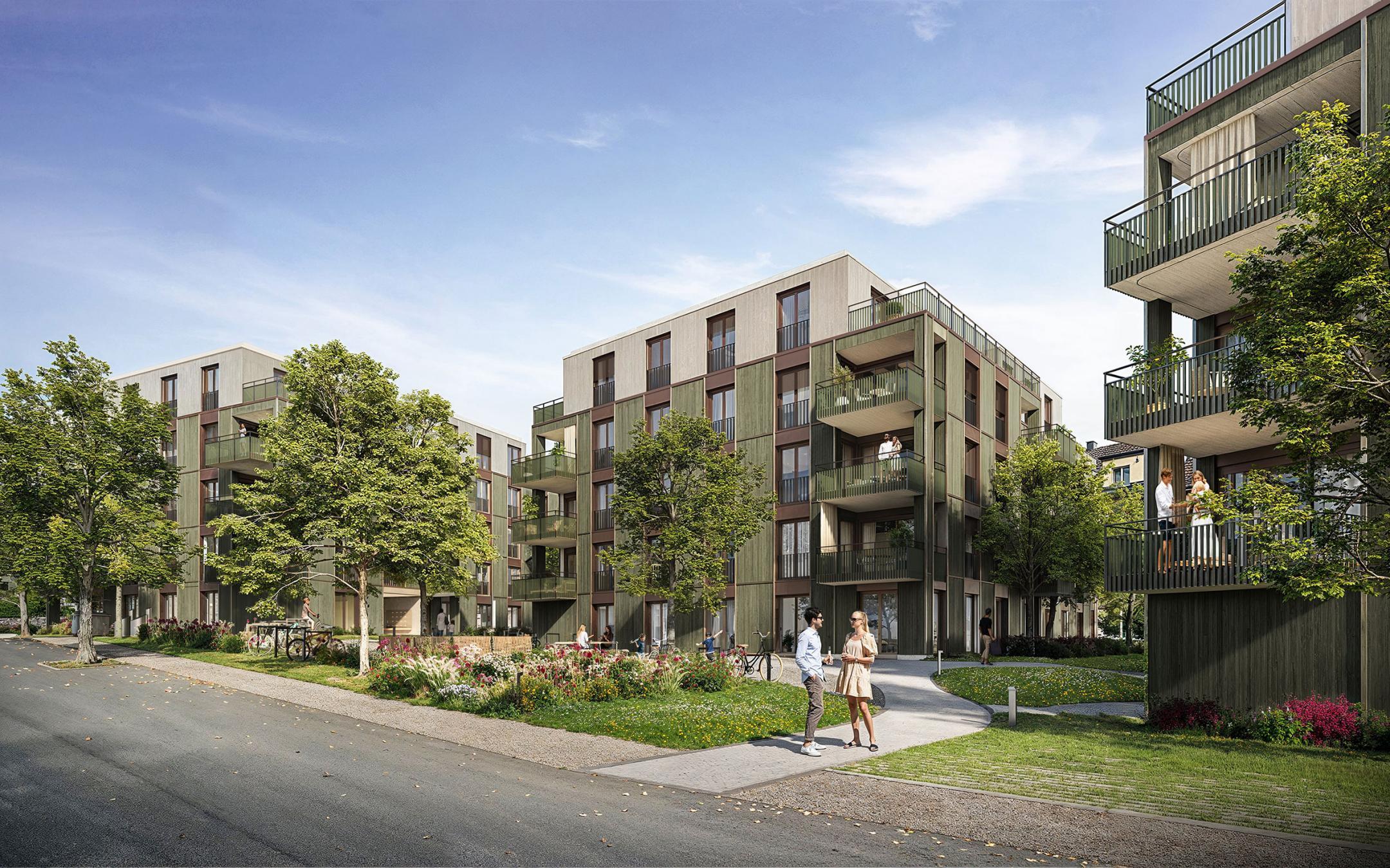 Ansicht mehrerer Holzgebäude entlang einer Straße mit Gehwegen, Grünflächen und Personen, die sich im Außenbereich bewegen.
