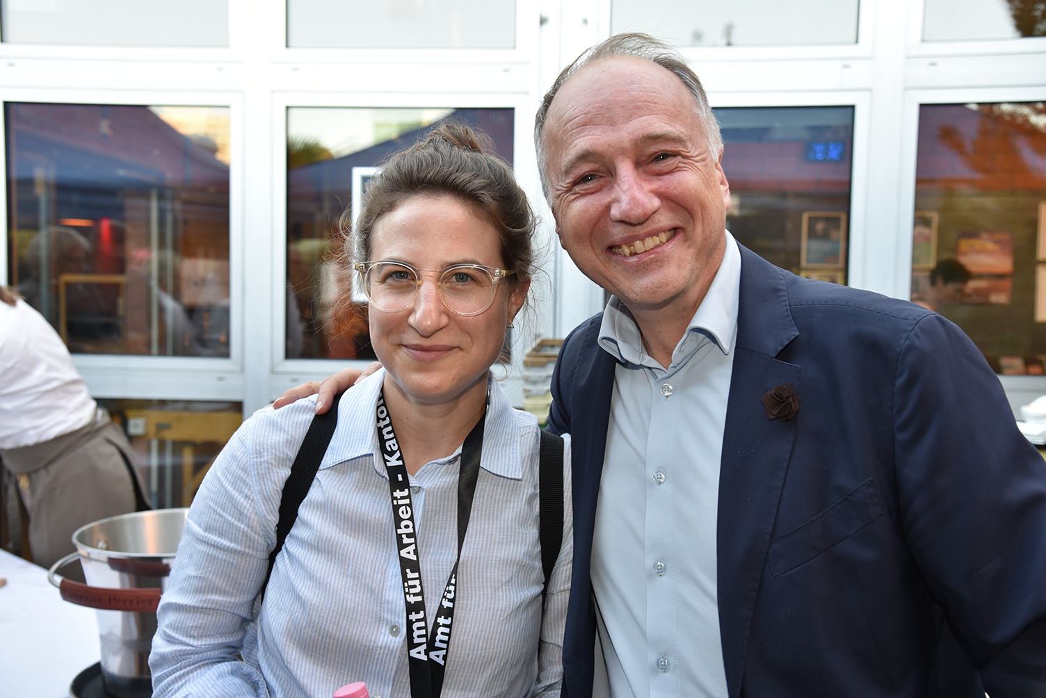 Eine Eventteilnehmerin und Referent Harry Witzthum lächeln in die Kamera.