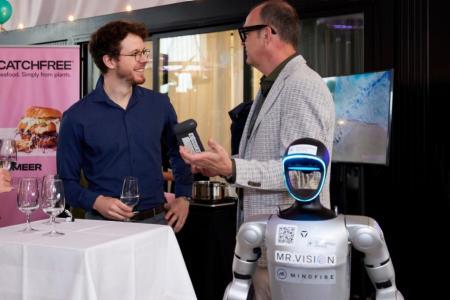 René Vogel erklärt einem Gast seinen humanoiden Roboter 