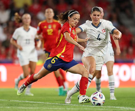 Szene aus dem Match mit zwei Spielerinnen im Vordergrund und weiteren Spielerinnen im Hintergrund. Die Spanische Fussballspielerin mit der Nummer 6 spielt den Ball. Die Zürcher Spielerin Noemi Ivelj versucht  ihr den Ball wegzuschlagen.